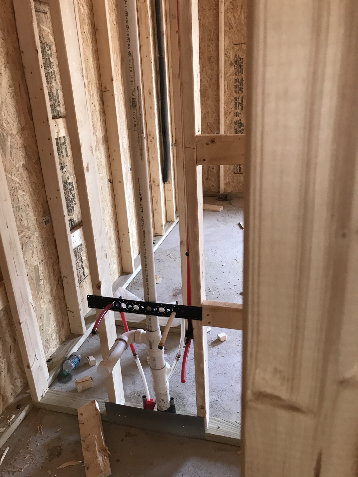 Plumbing rough-in inside new wood framing